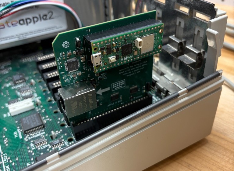 Seated in slot 7 of a IIGS. The Ethernet jack and the arrow point toward the keyboard, away from the back panel.
